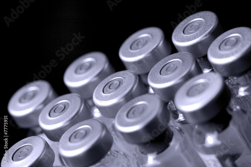glass vaccine phials on black