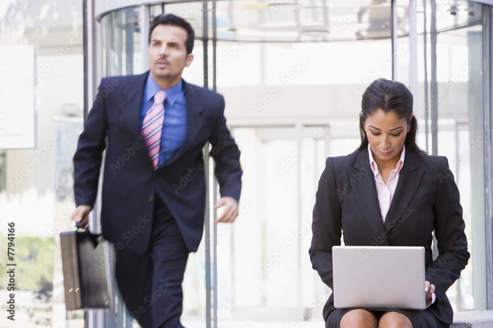 Businesswoman working at laptop outside Businesswoman working at laptop outside