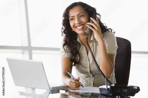 Businesswoman taking telephone call photo