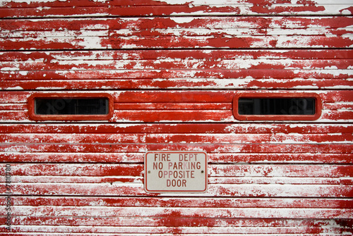 Vintage fire department garage door with peeling red paint