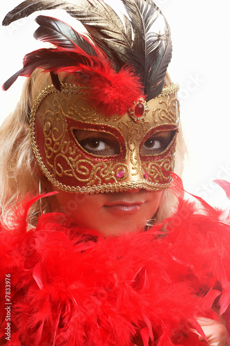 Young woman in red carnival mask
