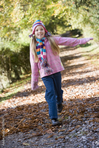 Young girl playing in woods