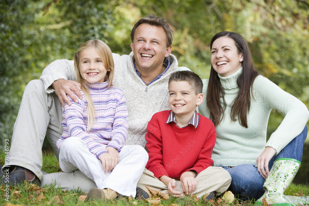 Family relaxing in woods