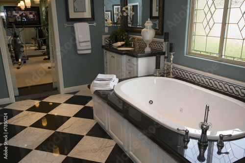 Spacious bathroom with a modern tub and tile floor.