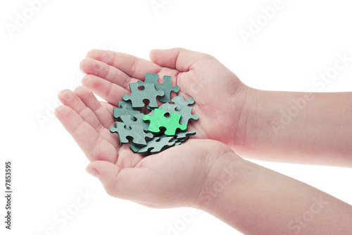 Hands holding pieces of jigsaw puzzle