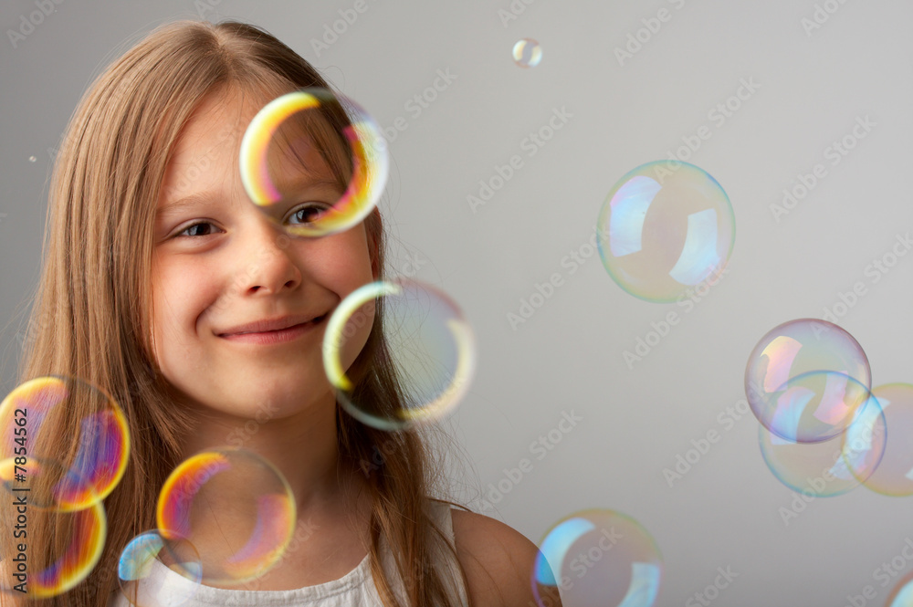 The happy girl and flying bubbles