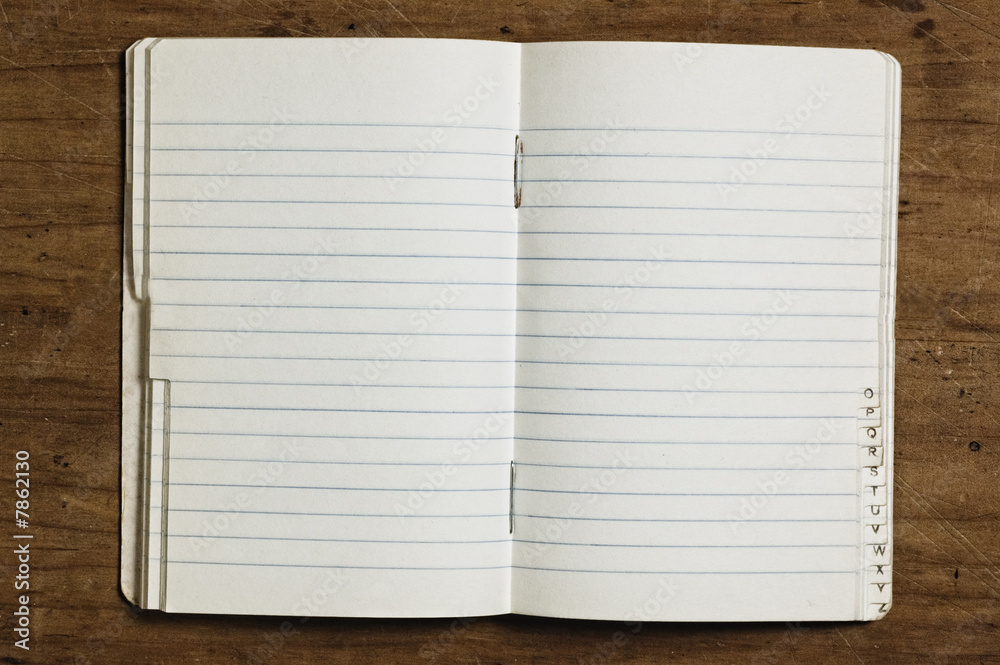 Indexed notebook on wooden table, studio shot. Indexed notebook on wooden table, studio shot.
