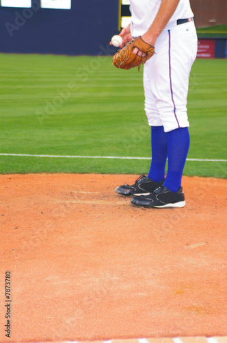 Baseball pitcher on the mound, starting throwing motion © zimmytws