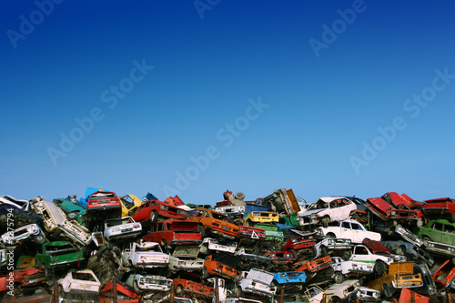 Pile of used cars in junkyard, ready for salvage photo
