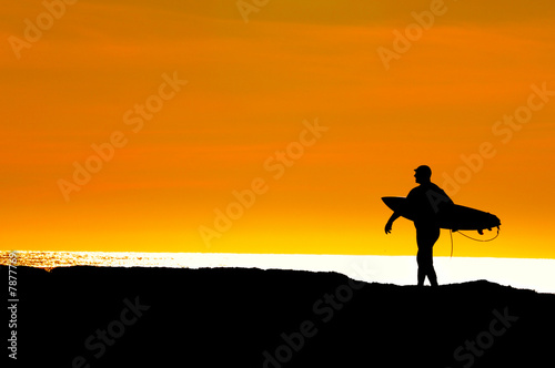 Surfer heading to sea for a sunset ride © Jeffrey Banke