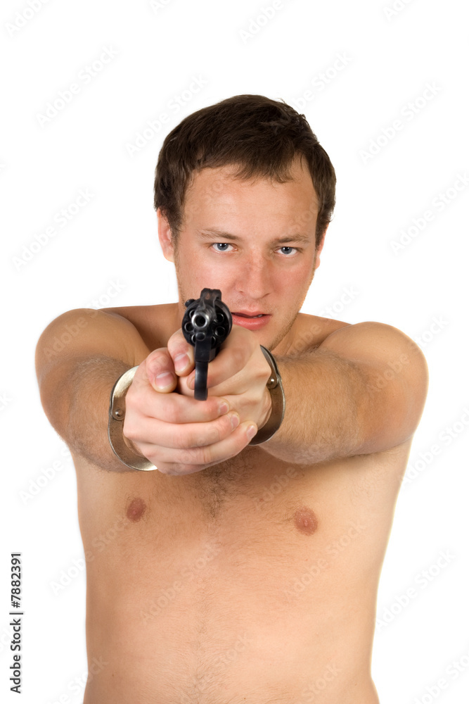 The guy chained in handcuffs with revolver. isolated The guy chained in handcuffs with revolver. isolated