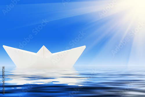 paper ship and blue water