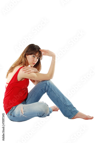 Thoughtful young girl siting on the floor