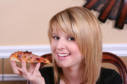 close up of girl eating pizza slice