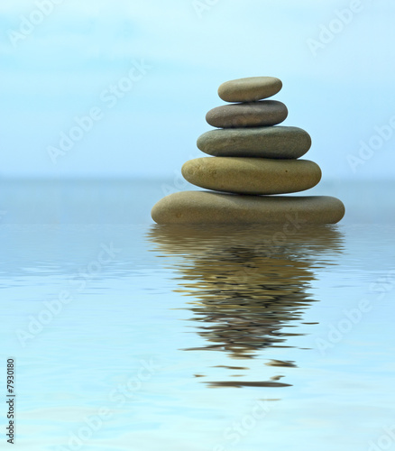 Pebble stack reflecting in the water