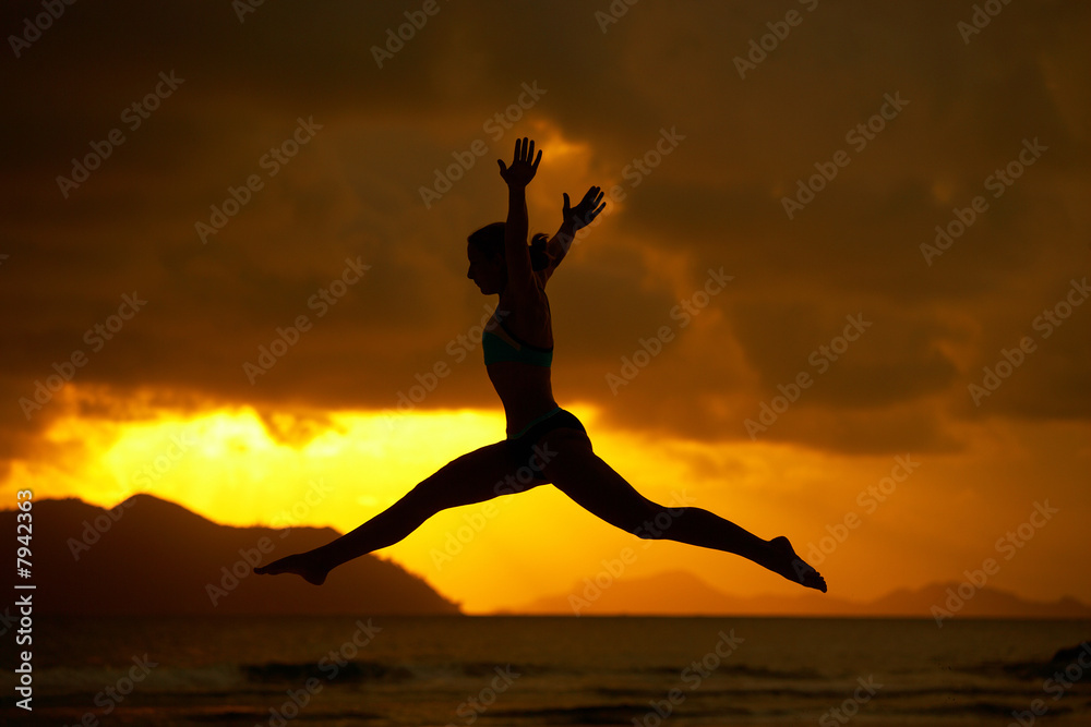 silhouette of jumping woman at sunset silhouette of jumping woman at sunset