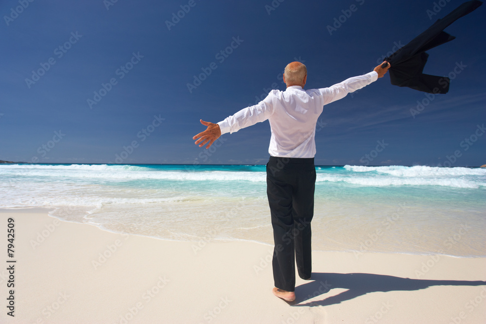 elderly businessman throwing away his suit on sandy beach elderly businessman throwing away his suit on sandy beach