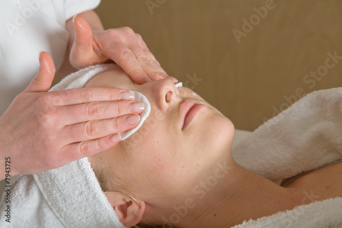 Closeup of human hands massaging a young pretty woman's face