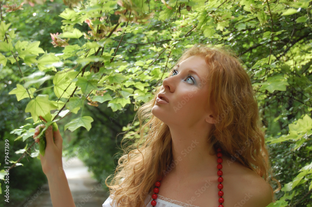 Beautiful red-head girl in woods