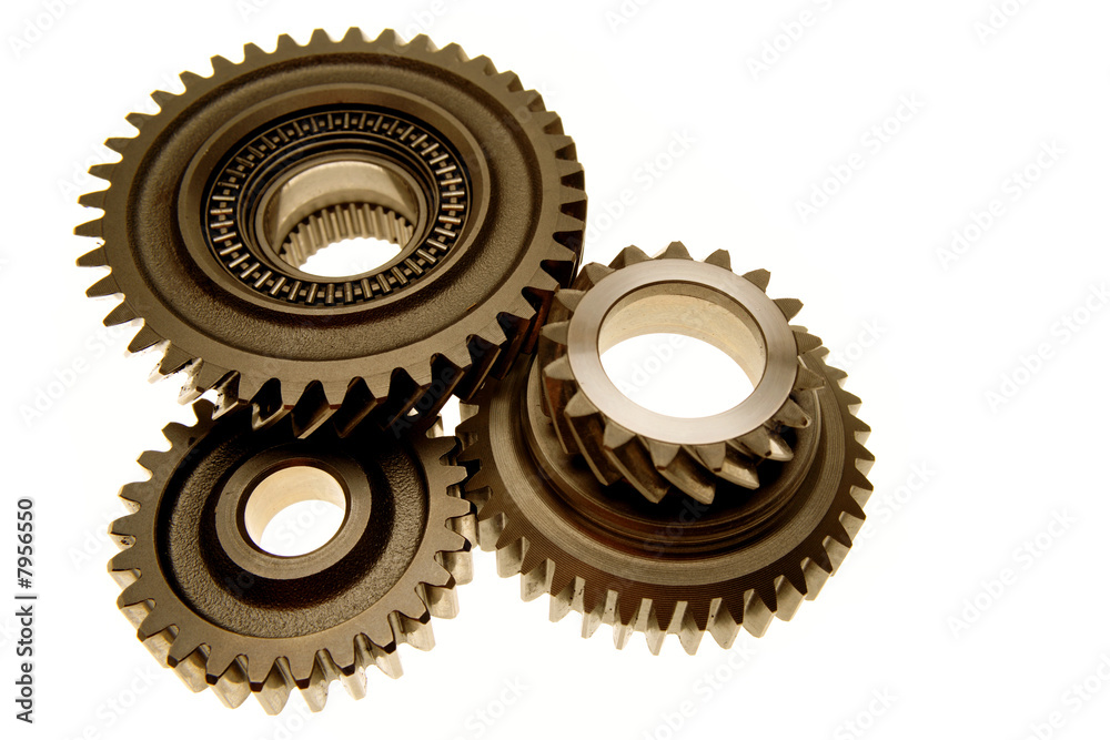 Three gears meshing together over white Three gears meshing together over white