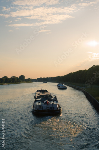 Frachtschiffe auf dem Wesel-Datteln-Kanal bei Sonnenuntergang photo