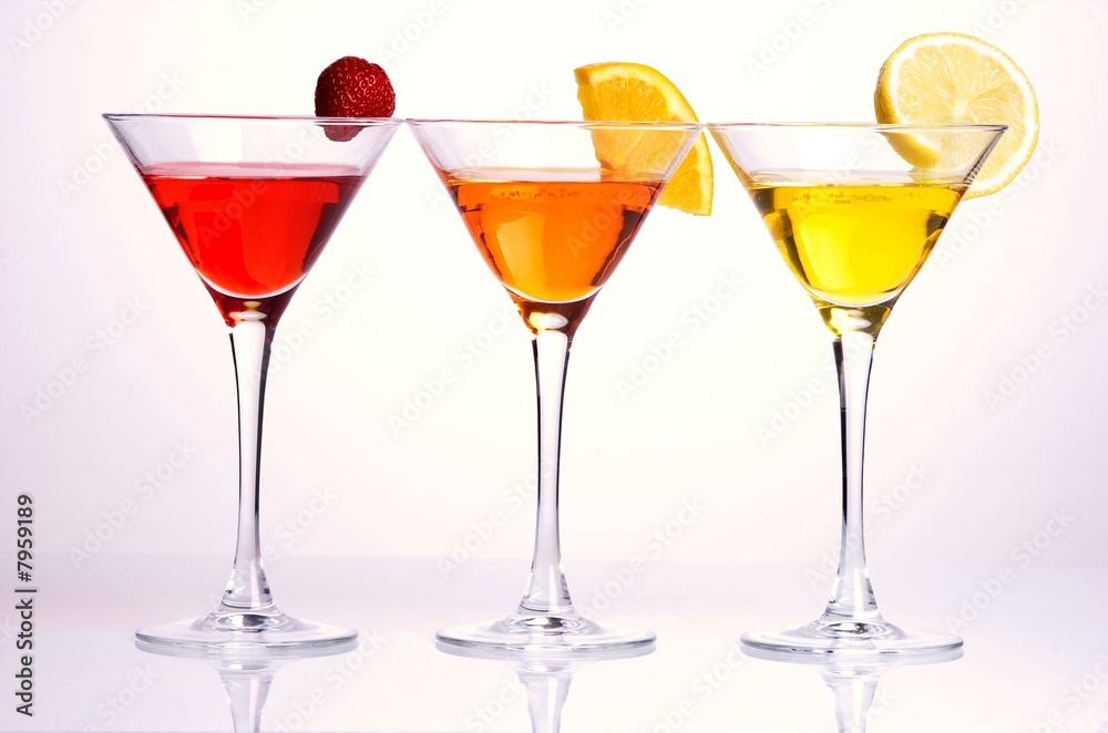Three colorful cocktails with fruits on white background