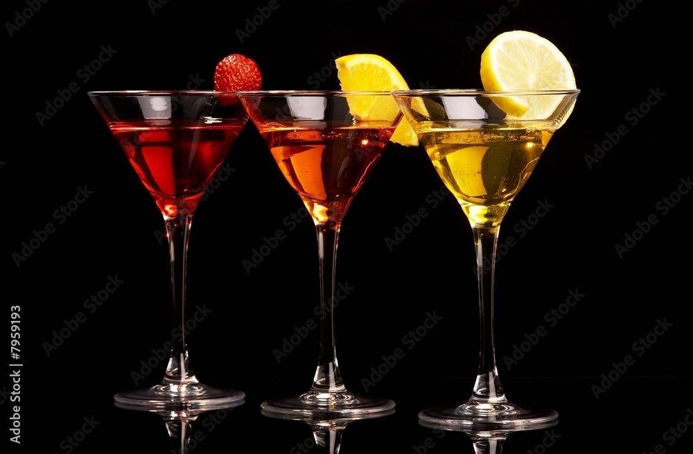 Three colorful cocktails with fruits on black background Three colorful cocktails with fruits on black background