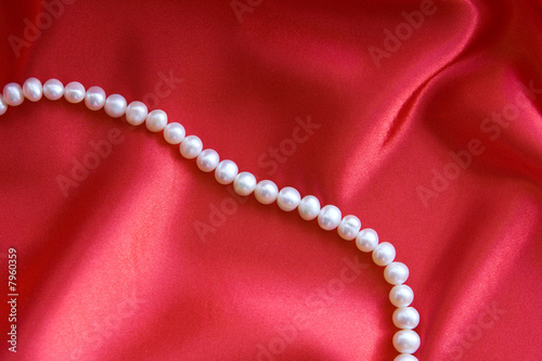 Pearls on a red silk fabric