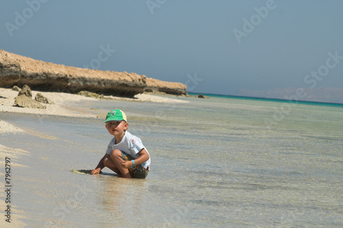 The little boy plays on a beach