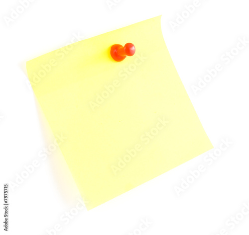Yellow sticky note and push pin on white