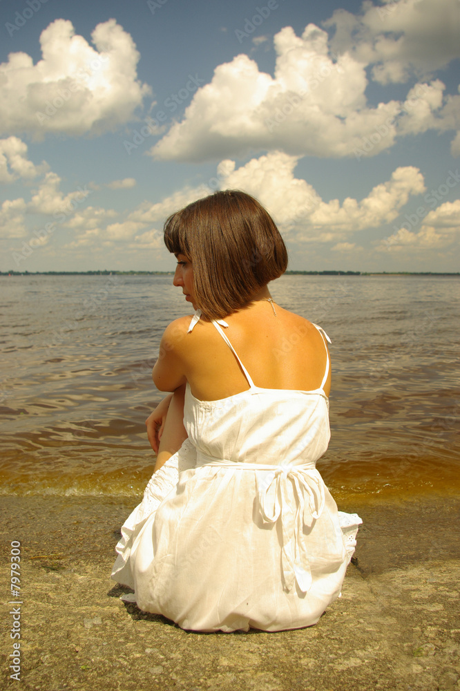 Attractive girl sitting and contemplating aloun Attractive girl sitting and contemplating aloun