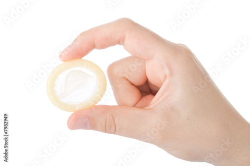 Hand holding a condom isolated on white background.