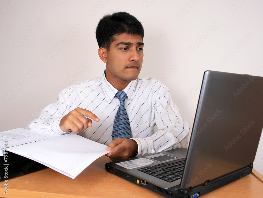 Young Indian business man working at his desk (Series) Young Indian business man working at his desk (Series)