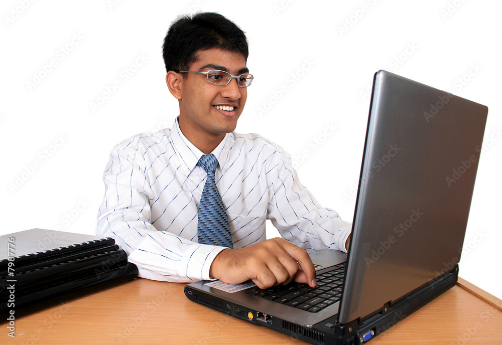 Young Indian business man working at his desk (Series) Young Indian business man working at his desk (Series)