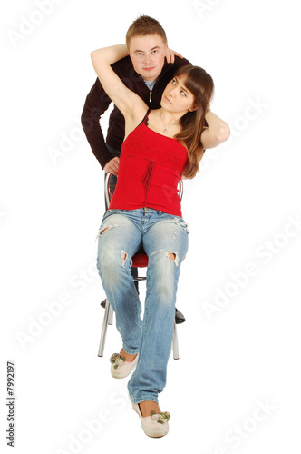 girl sitting on chair and embrace boy behind them