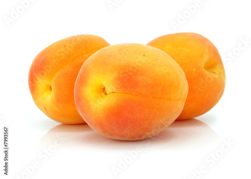 three fresh apricot fruits isolated