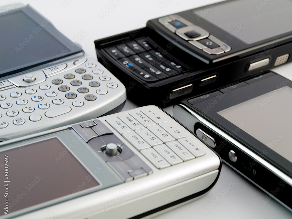 Stack Pile of Several Modern Mobile Phones PDA Cell Handheld Uni Stack Pile of Several Modern Mobile Phones PDA Cell Handheld Uni