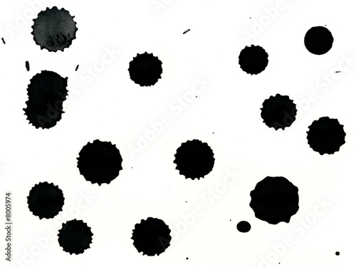 drips of black watercolor paint onto white background