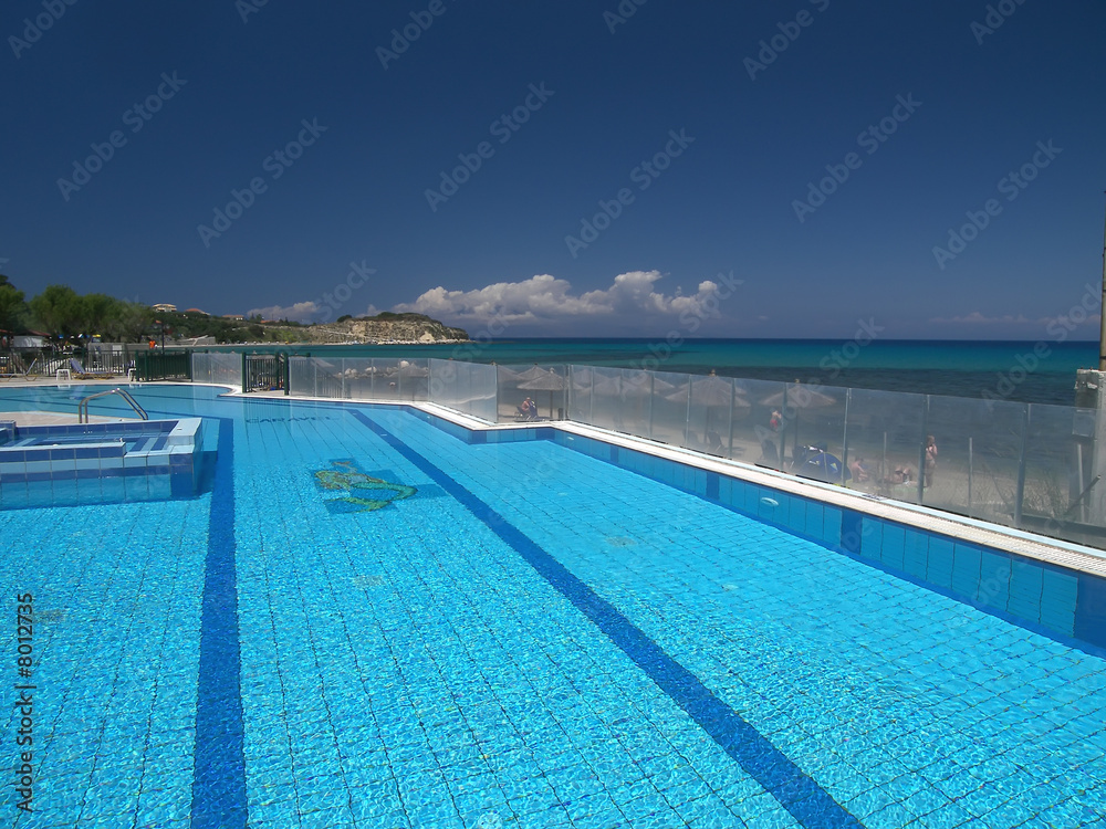 Fototapeta premium Blue swimming pool by sea.
