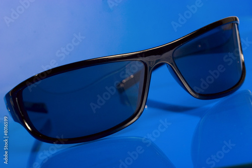 sunglasses over blue background