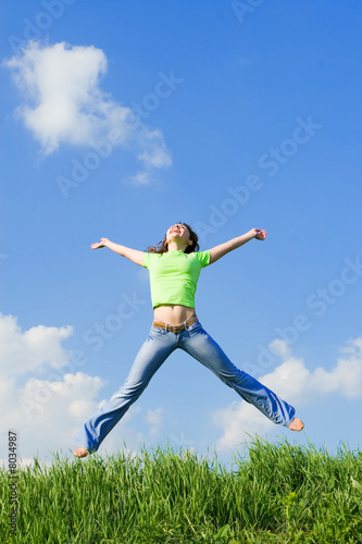 expressive young woman is jumping