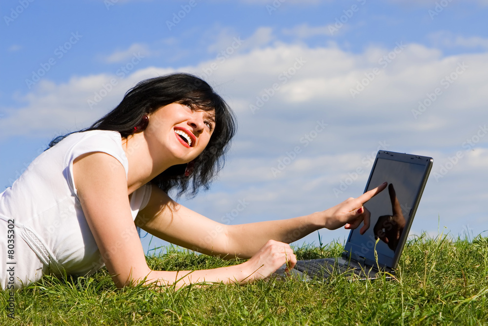funny woman with laptop on the green grass funny woman with laptop on the green grass
