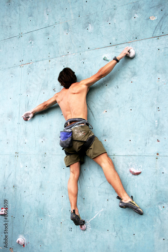 The climber trains on an artificial rock