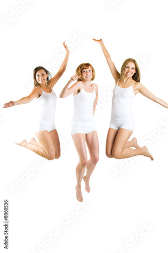 three beautiful smiling women are jumping isolated