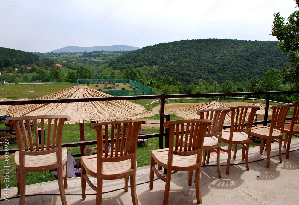 Wooden chairs on mountain terrace