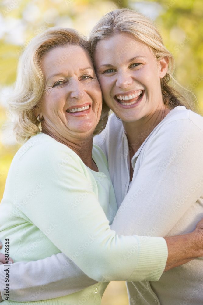 Mother hugging grown up daughter