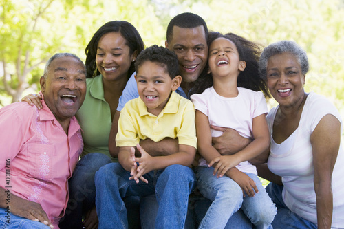Extended family sitting outdoors smiling