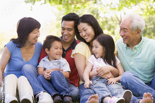 Extended family sitting outdoors smiling