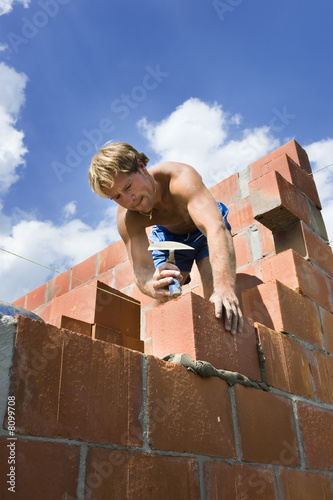 construction worker building a wall