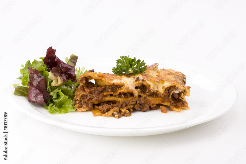 piece of lasagna al forno with some salad
